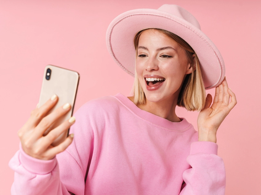 Woman taking selfie with phone